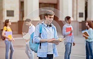 University Student Guy Reading Book Learning Standing Outside College Building