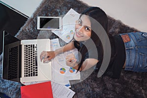 University student sit and do home work in computer notebook