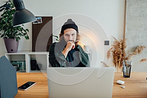 University student study while listening online lecture using laptop. Bearded hipster  doing home work