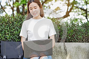 University student using internet search data for doing homework from computer in campus