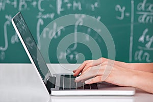 University student using laptop in classroom