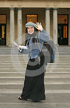 University - Student waving to fellow students