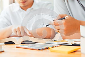 University students or college students studying and reading together in library