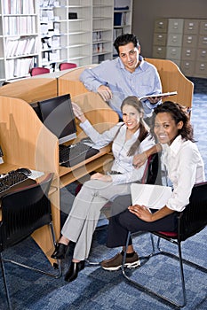 University students at library computer studying