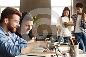 University students at library studying together and connecting online