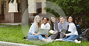 University students resting in campus, smiling to camera