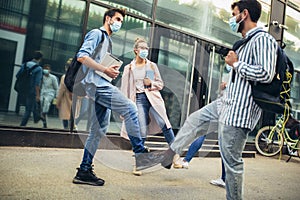 Students shaking legs outdoors, coronavirus and back to normal concept