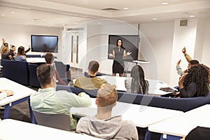 University students study in classroom with female lecturer