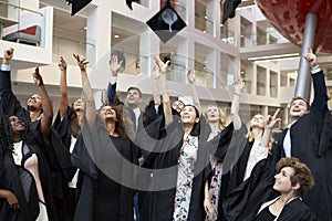 University students throwing their caps in the air on graduation day