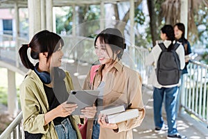 university students using a digital tablet while walking to next class