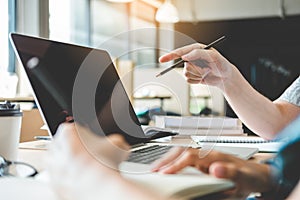 University students using laptop for research homework in college