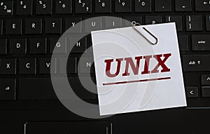 UNIX - word on a white sheet against the background of the laptop keyboard