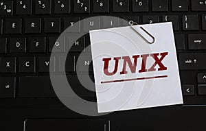 UNIX - word on a white sheet against the background of the laptop keyboard photo