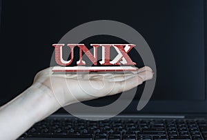 UNIX - word on a woman`s hand against the background of a laptop photo