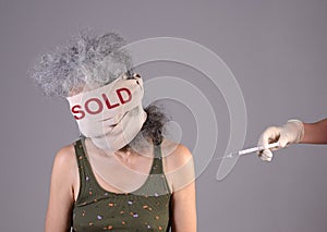 Unknowable woman bandages around head Hand with syringe