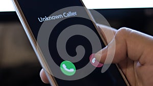 Unknown caller. A man holds a phone in his hand and thinks to end the call. Incoming from an unknown number at night. Incognito or