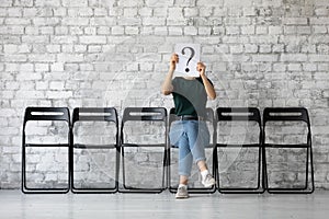 Unknown female applicant wait for interview in office