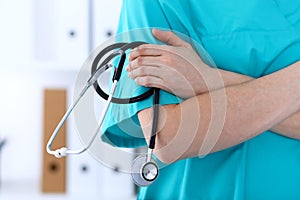 Unknown female doctor holds stethoscope closeup. Physician ready to examine and help patient. Medical help and insurance