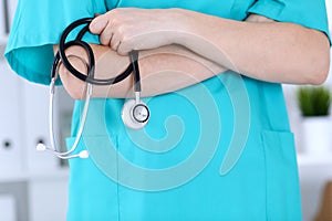 Unknown female doctor holds stethoscope closeup. Physician ready to examine and help patient. Medical help and insurance