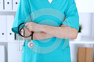 Unknown female doctor holds stethoscope closeup. Physician ready to examine and help patient. Medical help and insurance