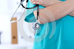 Unknown female doctor holds stethoscope closeup. Physician ready to examine and help patient. Medical help and insurance