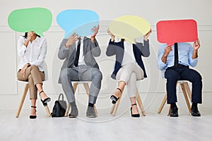 Unknown group of diverse businesspeople holding speech bubble while waiting for interview. Team of applicants together