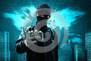 Anonymous hacker holding mobile phone