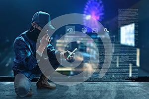 Unknown hacker use mobile phone on rooftop