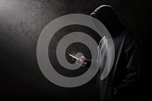 Unknown hacker using mobile phone