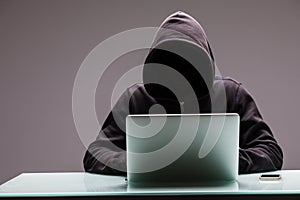 Unknown Hackers programmer using computer laptop for hack inform photo