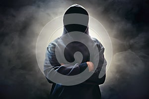 Hooded computer hacker on smoke background