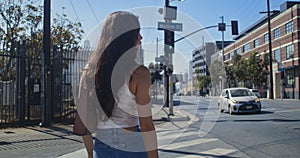 Unknown lady walking across road closeup. Stylish longhair woman go on crosswalk