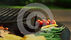 Unknown man chef preparing vegan bbq food outside. Vegetables cooking outdoor