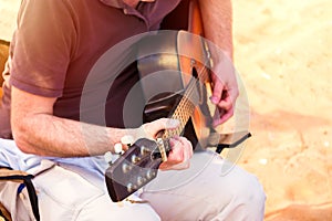 Unknown man playing music outdoor