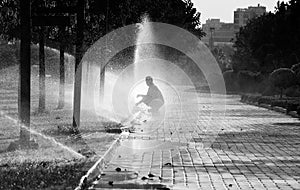 Unknown man under the sprinkler and water splash, Adana, Turkey