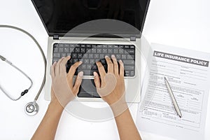 Unknown man use laptop to fill health insurance claim