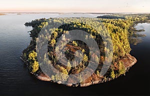 Unknown medieval Swedish watchtower at cliff of small uninhabited island. Drone view in Vyborg bay, gulf of Finland