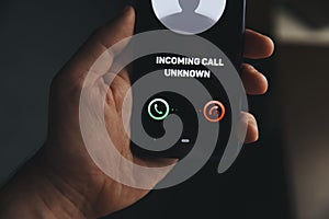 Unknown number calling in the middle of the night. Phone call from stranger. Person holding mobile and smartphone home