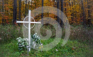 Unknown person grave marker in a deciduous forest.