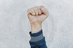 Unknown person protesting, activist fist up during strike. Activism for equal human rights or against racism, faceless human