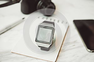 Unknown smart wrist watch laying on the table