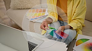 Unknown woman hands hold colors palette guide graphic designer architect girl choosing sample of material color tone