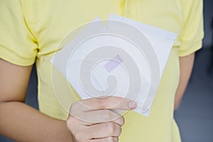 Unknown woman holding two menstrual pads