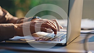 Unknown writer typing keyboard laptop at table close up. Hands pressing buttons