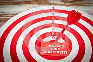 Unleash Your Creativity. Red target with dart