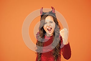 Unleashed fun. autumn holiday celebration. small child red horns. cute imp. trick or treat. happy halloween. cheerful