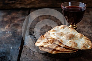 Unleavened bread with silver chalice of wine. Christian communion concept for reminder of Jesus sacrifice. Generative AI