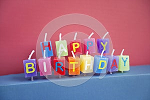 Unlit birthday candles over colored background photo