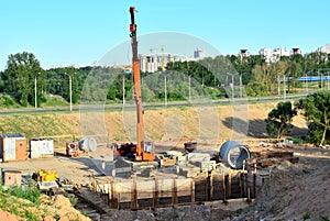 Unloading of cargo and building materials by mobile truck crane at the construction site.