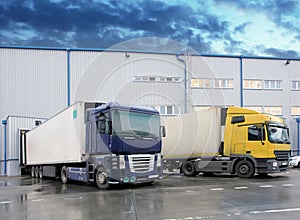 Unloading cargo truck at warehouse building